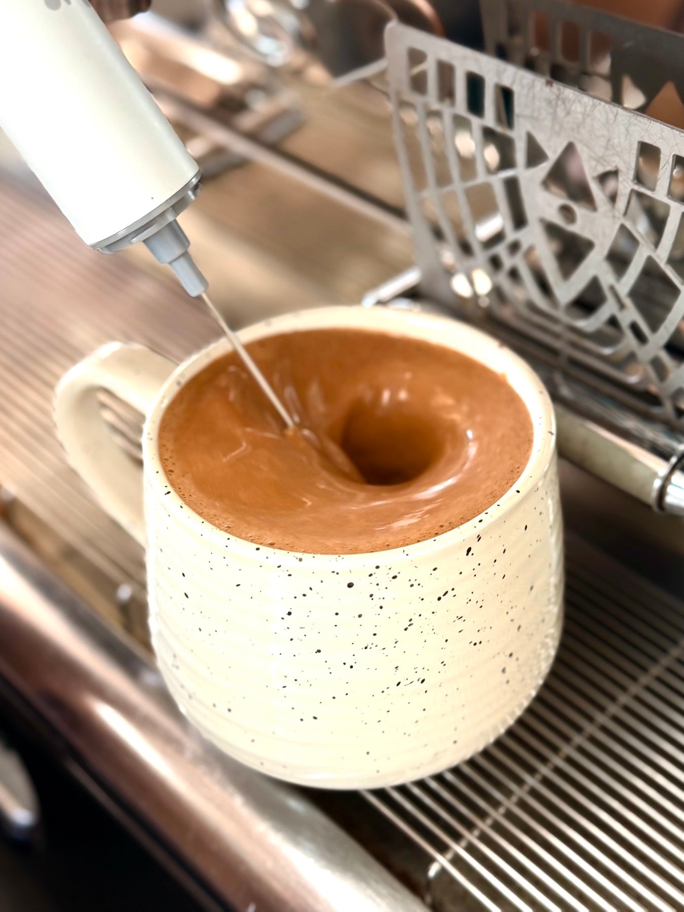 Chocolate drink being blended in a café cup